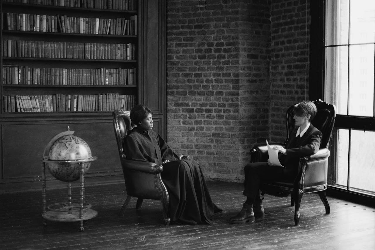 Two women having a serious conversation in a classic office setting, emphasizing a legal or business theme.